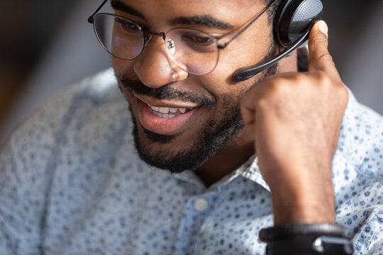 Close Up Face African Man Telesales Worker Working Wear Headset Contacting Customers To Inform Them About Service, Answer Questions About Products. Call Center Operator Agent, Clients Support Concept