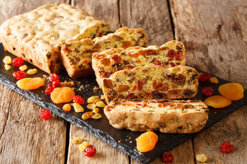 Healthy food fruit cake with dried apricots berries raisins figs cherries closeup on a slate board on the table. horizontal