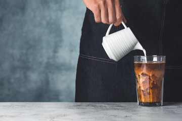 space ice coffee with hand pour milk food background