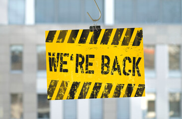 Office building with message we are back after the corona lockdown