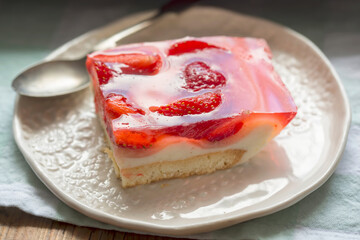 Sponge cake with yoghurt and lemon layers with strawberries and jelly 