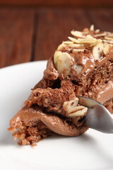 Fototapeta na wymiar Chocolate sandwich cake garnished with flaked almonds