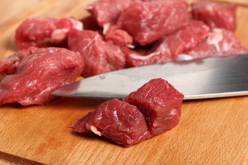 Diced beef casserole steak on cutting board