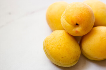 Ripe apricots on a white background closeup photo of seasonal summer fruits