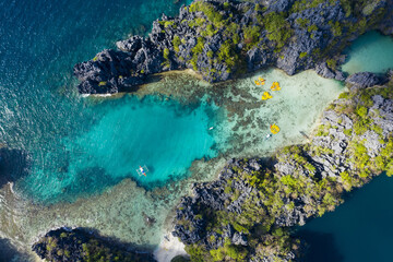 Fototapeta na wymiar View from above, stunning aerial view of the Big Lagoon and the Small Lagoon, two beautiful bays of crystal clear water surrounded by rocky cliffs. Bacuit Bay, El Nido, Palawan, Philippines.