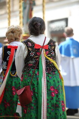 Naklejka premium Women in traditional folk feale costumes from Krakow, Poland, while join annual Corpuc Christi procession in city center