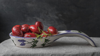 red olives and a rosemary sprig