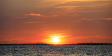 Fototapeta na wymiar Beautiful sunset orange sky over fisherman village