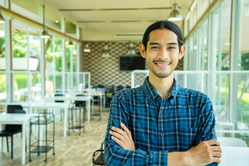 Asian owner business standing and smiling  inside