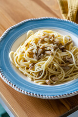 Homemade Spaghetti with Mushroom and Cream Sauce on Rustic Wooden Table .