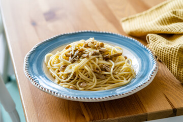 Homemade Spaghetti with Mushroom and Cream Sauce on Rustic Wooden Table .