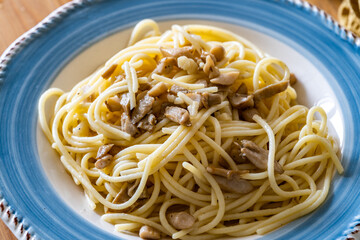Homemade Spaghetti with Mushroom and Cream Sauce on Rustic Wooden Table .