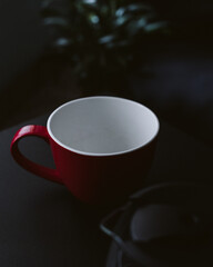 red cup of coffee on black background