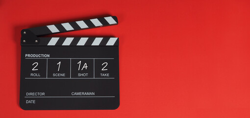 Fototapeta na wymiar Clapper board or movie slate .It is use in video and cinema industry on red background.