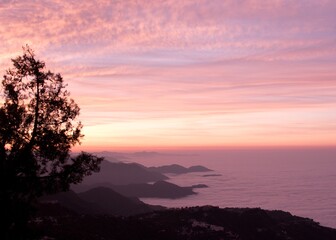  landscape view of sunrise over the mountains with fog & clouds
