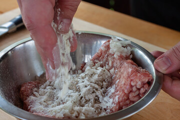 mixing minced meat with spices for cutlets. cooking burgers.