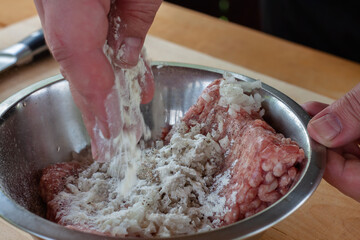 Fototapeta premium mixing minced meat with spices for cutlets. cooking burgers.