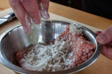 mixing minced meat with spices for cutlets. cooking burgers.