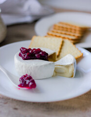 camembert and waffles with berries and jam