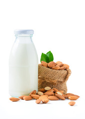 Bottle of milk and Almonds nuts with leaf isolated on white background,