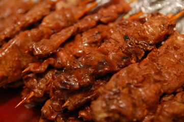 Grilled barbecue inserted in stick with marinated sauce