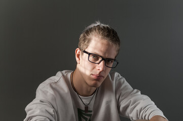 Portrait of young blond man photographed with natural light and casual clothes.