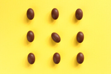 Chocolate eggs on yellow background