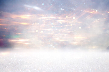 glitter vintage lights background. gold, silver and white. de-focused