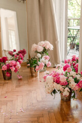Fototapeta na wymiar bouquets of peonies at home near balkony