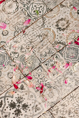 Old tile with rose petals