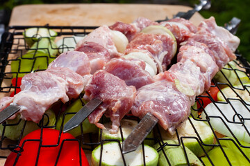 fresh pork meat on a skewer. preparation of a shish kebab.