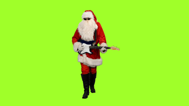 Santa rock guitarist in sunglasses playing guitar on green screen background, chroma key - Powered by Adobe