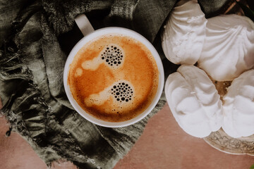 Cup of fresh espresso coffee and zephyr on platter.