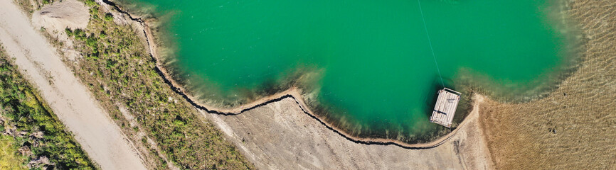 Geometrically shaped edge of a gravel quarry, abstract aerial view