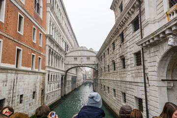 Decorative archway over a canal connecting two buildings.