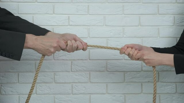 Competition in business. Two businessmen are tug of war.