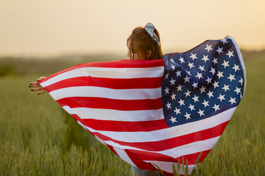 Independence day concept with woman lying down on american flag