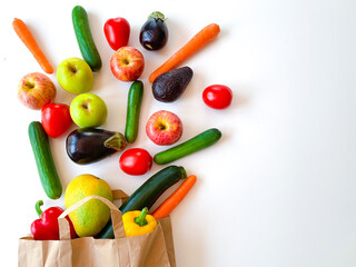 Food tomatoes, cucumbers, apples, pepper, carrot and different vegetables and fruits in a paper bag...