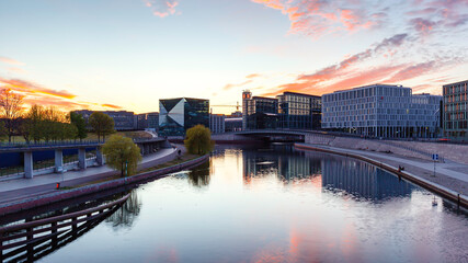 Berlin sunset cityscape view with spree river and office buildings