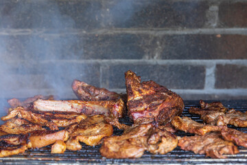 Meat on the barbecue grill, beef steak in smoke from fire