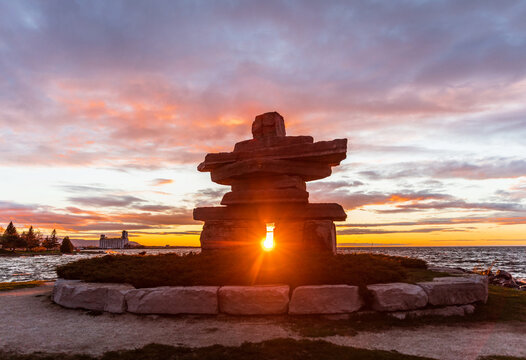Sunset framed behind Inukshuk in Collingwood waterfront park