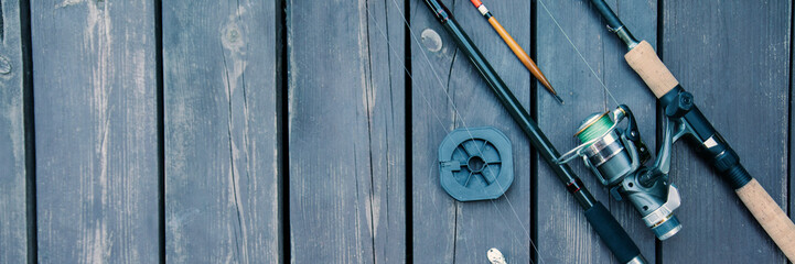 Fishing rods and reels on the wooden deck, fishing copy space