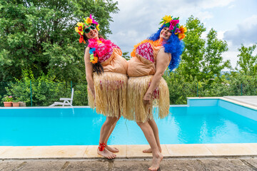 two female friends in fat Hawaiian costumes have fun