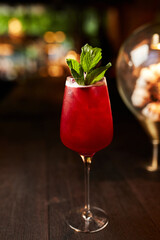 Close up red berries lemonade cocktail with mint. Strawberry lemonade on dark background.