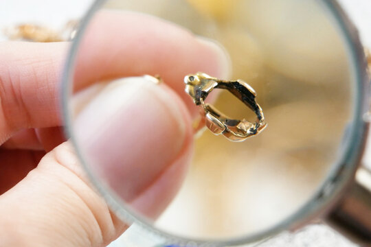 jewelry scrap of gold and silver and money, pawnshop concept jeweler looking at jewelry through magnifying glass, jewerly inspect and verify - Powered by Adobe