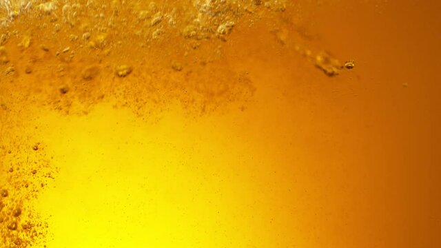 Super Slow Motion Detail Shot of Pouring Beer into Glass at 1000fps.