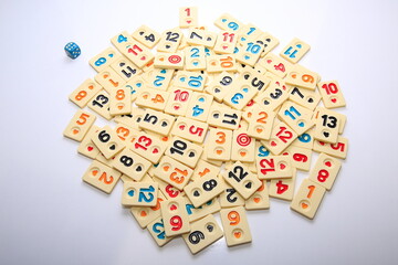Turkish board game Okey (Rummikub). 
Stack composition with game pieces on white ground.