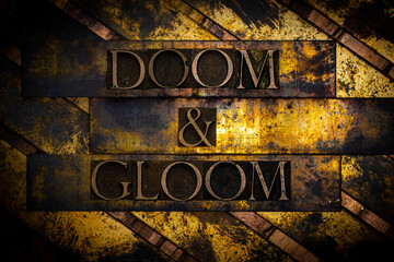 Doom and Gloom text formed with real authentic typeset letters on vintage textured silver grunge...