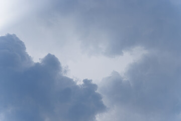 Obraz premium Stormy rain big fluffy clouds. Dark sky. Natural scenic abstract background. Weather changes backdrop. Sky filled with voluminous clouds.