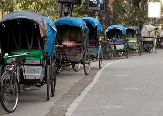 old human pulled rickshaw carriage in the street